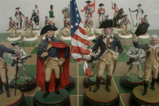 Closeup of figures from Revolutionary War chess set, including George Washington at left of flag. Image courtesy of Professional Appraisers & Liquidators.