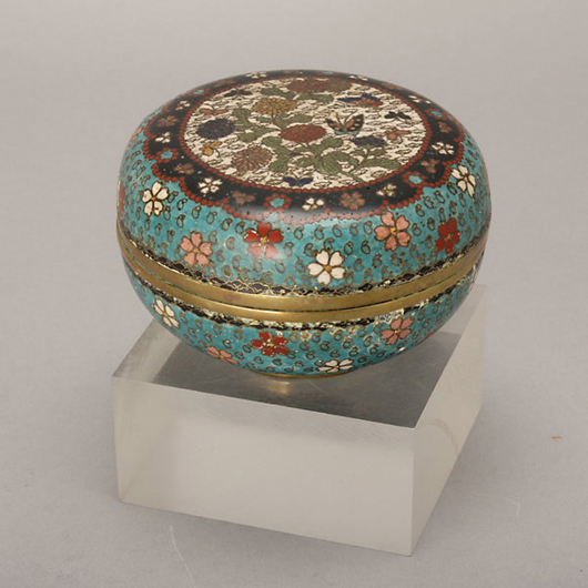 Cloisonné enameled box, 19th century, decorated with a flower and butterfly theme, diameter: 4 3/4 inches. Estimate: $500-$700. Image courtesy of Michaan’s Auctions.