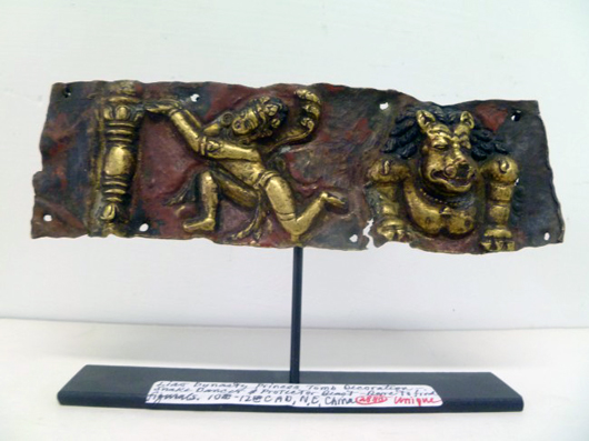 Deeply embossed copper tomb art of Buddhist Lion-Protector and other significant figures, 6 1/2 inches wide by 2 inches tall, est. $3,000-$5,000. Asian Antiques Gallery.