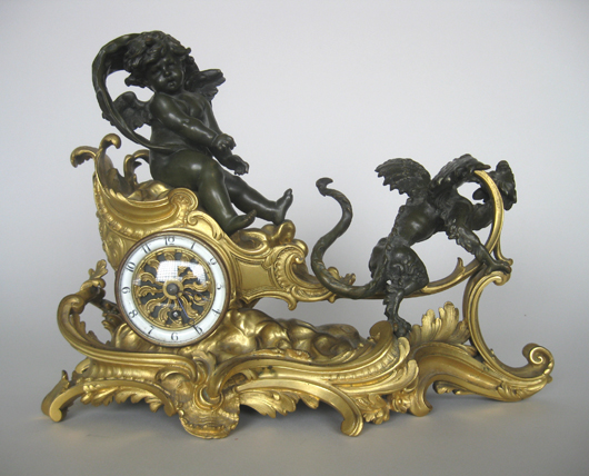French gilt bronze clock of a cherub in a chariot pulled by a winged dragon, 11 x 14 x 6 inches. Estimate: $400-$600. Image courtesy of Rachel Davis Fine Arts.