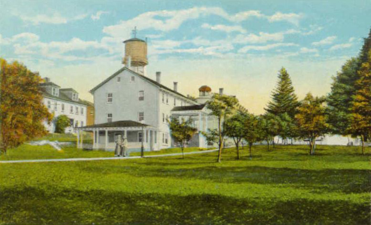 Image on circa-1920 postcard published by the Canterbury Shaker Village and showing a view of some of the compound's buildings.