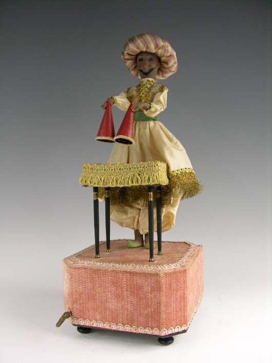 Rare musical automaton playing ‘The Blue Danube,’ while switching dice, cards and a plate beneath two cones, 19 3/4 inches high. Estimate: $4,000-$6,000. Image courtesy of Antique Place.