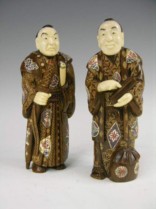 Pair of carved ivory and wood Japanese men, each signed on the bottom, 8 inches tall, each signed on the bottom. Estimate: $2,000-$3,000. Image courtesy of Antique Place.