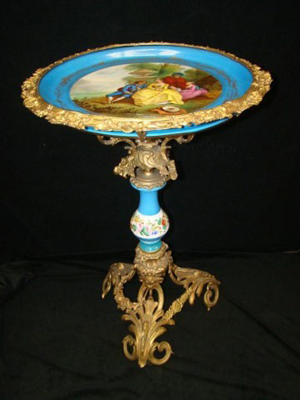 French Sevres gilt ormolu porcelain-top table, 30 inches tall by 19 inches wide, est. $3,000-$6,000. Tonya A. Cameron Auctioneers image.