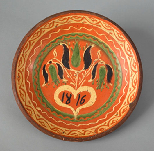 The bright colors, intricate patterns, and date add value to this round plate, but the clincher is the inclusion of a heart. The lot brought $105,300 in an April 2007 sale. Image courtesy of Pook & Pook.