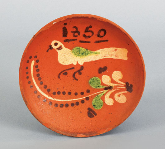 Collectors look for inventive designs on redware plates. This example, sold for $37,920 in 2010, offers a lively bird under the date 1850. Image courtesy of Pook & Pook.