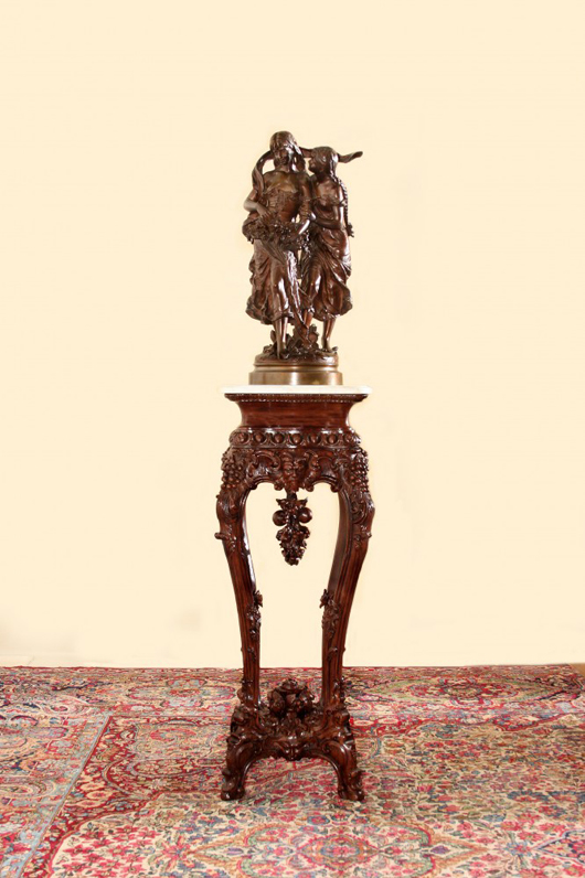 Bronze statue perched atop a 19th-century rosewood rococo marble-top pedestal. Image courtesy of Kennedy’s Auction Service.