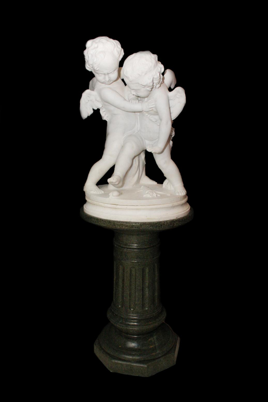 Nineteenth-century marble statue of Cupid and Putto wrestling, on the original green marble pedestal. Image courtesy of Kennedy’s Auction Service.