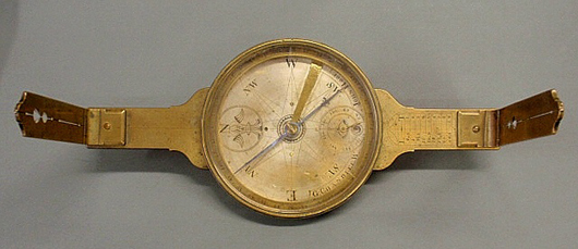John Hooe surveyor's compass by Goldsmith Chandlee, Winchester, Va., circa 1790, inscribed on the face in an engraved banner ‘G. CHANDLEE W. and JOHN HOOE,’ 14 1/2 inches x 5 inches, outside dial 6 1/4 in diameter.  Estimate: $20,000-$25,000. Image courtesy of Wiederseim Associates Inc.