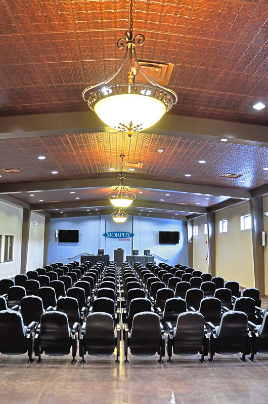 Morphy’s new, purpose-built saleroom with theater-style seating, a chandeliered decorative tin ceiling and polished faux-marble floor. Morphy Auctions image.