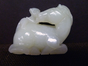 Imperial jade carving of a monkey climbing on the back of a recumbent horse, 18th century, near-white color, est. $18,000-$25,000. Asian Antiques Gallery image.