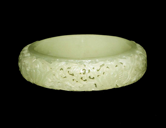  Superb pale celadon jade bangle, Chinese, solid inner ring, pierced outer ring with foliate and bat design. Image courtesy of Auction Gallery of the Palm Beaches. 