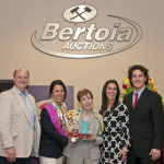 Sally Kaufman (center) holding Donald Kaufman’s first toy purchase, an Arcade International Harvester truck, which was presented to her as a gift from Bertoia’s and members of the toy community. Left to right: Rich Bertoia, Jeanne Bertoia, Sally Kaufman, Lauren Bertoia-Costanza, Michael Bertoia. Bertoia Auctions image.