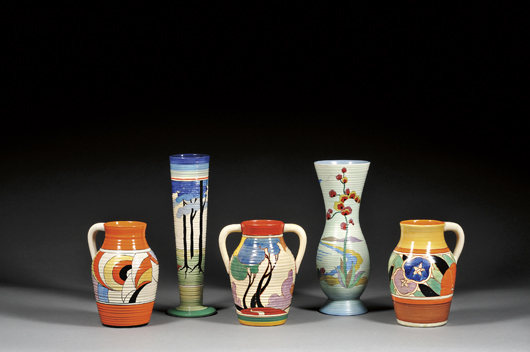 From left to right, a Fantasque Swirls jug sold for $3,081; a Bizarre Ware Blue Firs vase $1,778; a Fantasque Autumn or Balloon Trees two-handled jug $3,851; a vase with stemmed flower $356; and a Fantasque Gardenia Jug $1,422. Courtesy Skinner Inc.