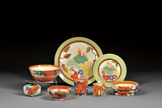 Summer fruits and flowers brighten Cliff designs. The Oranges sugar and bowl brought $296, a Bizarre Ware Alton charger and plate $1,185, and a lot of five varied Fantasque pieces $1,778. Courtesy Skinner Inc.