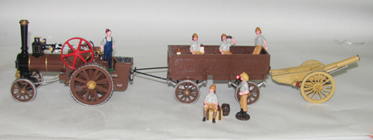 9-piece set by Trophy, includes steam tractor, wagon, Howitzer and six men, $840. Old Toy Soldier Auctions image.