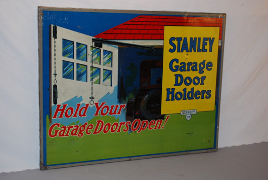 Stanley Garage Door “Hold Your Garage Doors Open!” single-sided tin sign: $3,520. Image courtesy of Matthews Auctions LLC.