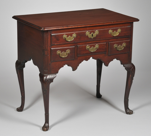 Queen Anne carved walnut dressing table with paw feet. Estimate $600-$800. Image courtesy of Skinner Inc.