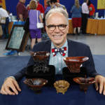 Antiques Roadshow appraiser Lark Mason with the collection of Chinese rhinoceros-horn cups appraised at the TV show's stop in Tulsa, Oklahoma. Image copyright Antiques Roadshow, used by permission.
