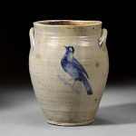 William Capron stoneware jar with incised cobalt flower and bird decoration, Albany, N.Y., circa 1800-05, the front and back decorated with incised cobalt blue decoration, one side depicting a flower blossom, the other a bird, 13 3/8 inches high. Estimate $2,000-$3,000. Image courtesy of Skinner Inc.