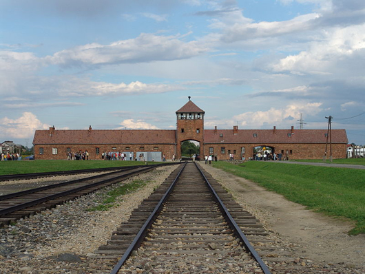 The main gate at the former Nazi death camp of Birkenau. Aug. 2006 photo by Angelo Celedon a k a Lito Sheppard, licensed under the Creative Commons Attribution-Share Alike 2.5 Generic license.