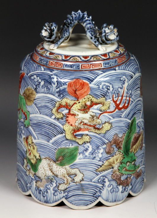 Wucai porcelain bell, China, 17th /18th century, decorated with mythical animals on a blue wave-patterned ground, dragon-form handle and scalloped bottom edge, 7 inches high x 5 inches diameter. Estimate $6,000-$9,000. Image courtesy of Kaminski Auctions. 