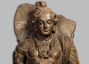 Standing Bodhisattva Maitreya, Pakistan, 3rd–4th century, grey schist. H. 39 3/8 x W. 15 3/16 x D. 5 1/2 in. (100 x 38.5 x 14 cm). Central Museum, Lahore, G-131. Image courtesy of Asia Society.