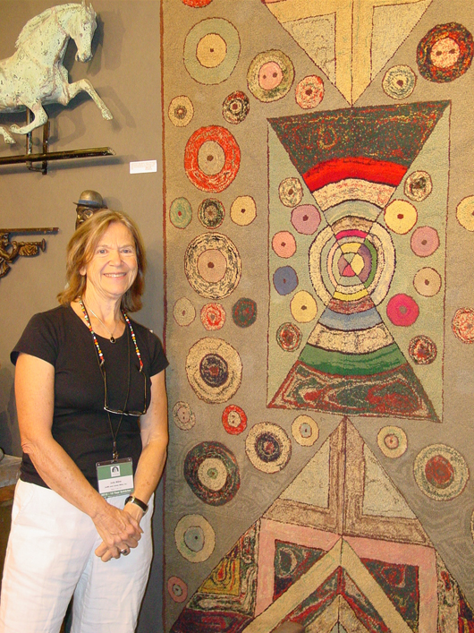 New York dealer Judith Milne with an outstanding coin-dot rug. Archival photo copyright Catherine Saunders-Watson.