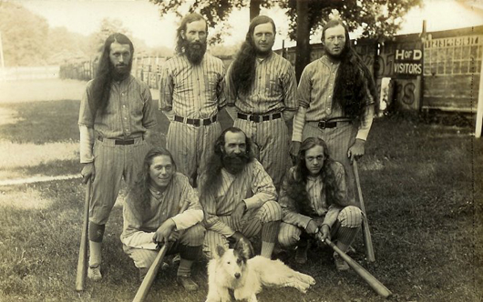 1928 photo of one of the greatest House of David baseball teams, with their canine mascot who traveled with them. Front, left to right: Mud Williams, Horrace Hannaford, George Anderson. Back: Dave Harrison, Percy Walker, Tom Dewhirst and Bob Dewhirst. Percy Walker signed a baseball bat along with Babe Ruth that year stating he was the only one who had ever struck out Ruth twice in one game. Image courtesy of House of David Museum.