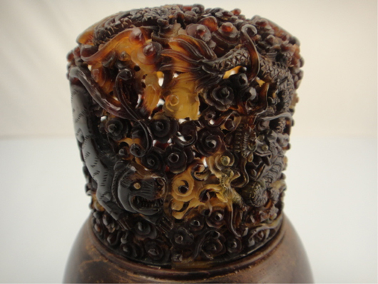 A gourd cricket jar is fitted with wood mounts and rare openwork carved tortoiseshell top, which   features carved tiger and dragon motifs amid swirling clouds. Standing 9 1/2 inches high with a four-character Qianlong mark on its base, Lot 322 commands a high estimate of $2,000. Image courtesy of 888 Auctions.