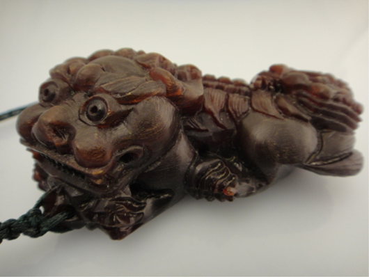 Chinese carved rhinoceros-horn pendant of lion, $850. 888 Auctions image.