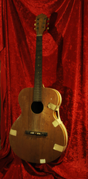 Elvis Presley’s first guitar, a gift on his 11th birthday, January 1946. Est. $350,000-$500,000. Guernsey’s image.