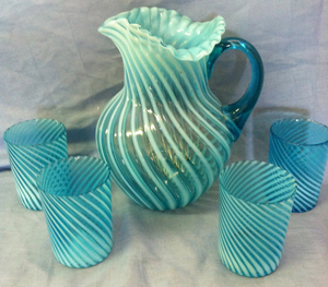 Colorful and early Northwood water set, opalescent blue swirl with four tumblers. Image courtesy of Specialists of the South.