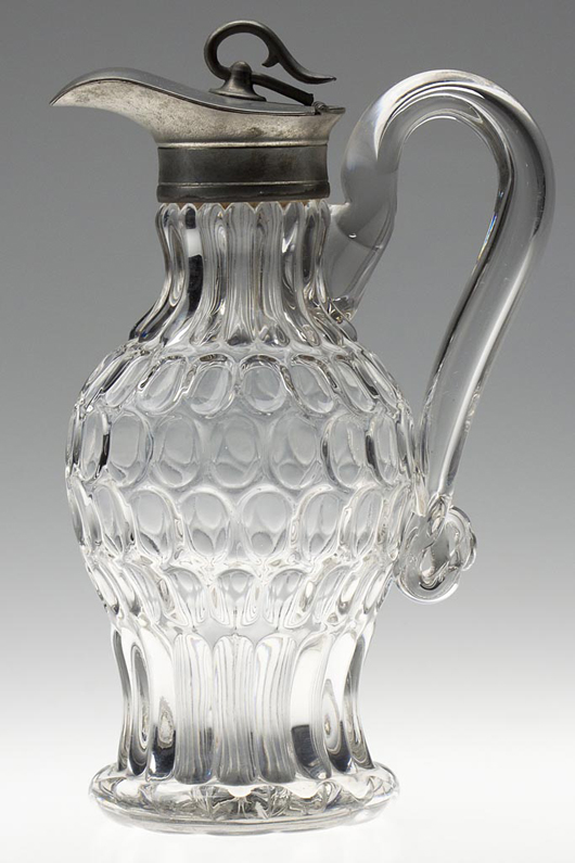Early Thumbprint / Argus molasses pitcher / jug, blown-molded colorless lead glass with original Britannia hinged lid. Bakewell, Pears & Co., Pittsburgh. Estimate: $2,000-$3,000.