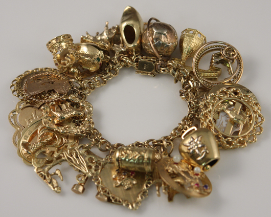 Solid gold charms acquired in Europe, Africa and South America decorate this bracelet. Image courtesy of Stefek’s Auctioneers & Appraisers.