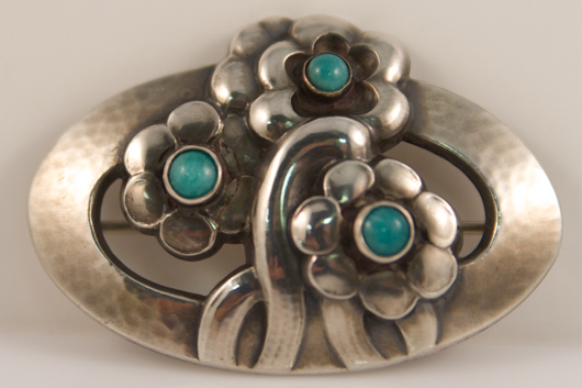 Marked no. 28, this Georg Jensen brooch is paired with a set of earrings of similar design. The have an $800-$1,000 estimate. Image courtesy of Stefek’s Auctioneers & Appraisers.