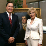 Mike Lowenberg and Joanne Herring with the Raeburn painting. Image courtesy of De Andre Moore, DM Video Production.