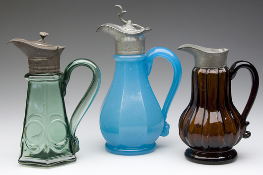Samples from the Watt White collection of rare early colored syrup jugs. Image courtesy of Jeffrey S. Evans & Associates.