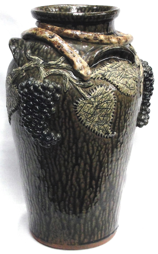 Exquisite Meaders family Southern pottery jug with applied snake, grapes-and-leaves motif. John W. Coker Auctions image.   