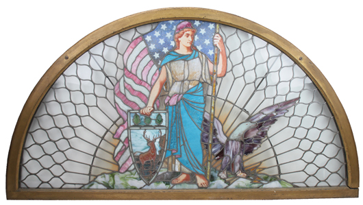 Half-round leaded-glass window featuring Liberty figure, from a Hartford Insurance Co. building, 82 inches wide by 44 inches tall, est. $7,000-$10,000. Noel Barrett Auctions image.