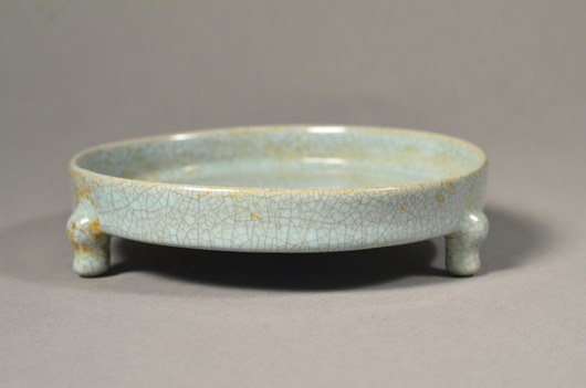 Rare Song Dynasty Guanyao celadon tripod dish covered with a pale grey glaze suffused with crackle realized a hammer price of $10,890. Image courtesy of 888 Auctions.