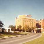 A view of Dealey Plaza in Dallas showing the former Texas School Book Depository. Copyright by James G. Howes, 1969. Image courtesy of Wikimedia Commons.