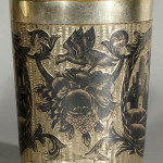 Russian silver and niello silver beaker, 1814, with two exotic niello scenes featuring urban landscapes with palm trees, surrounded by flower festoons with birds and fruit, height: 3 1/4 inches, assayer's marks 'I.B. 1814' and 'Senik' on base, Moscow town mark, 84 standard. Estimate: $1,500-$2,000. Image courtesy of Gene Shapiro Auctions LLC.