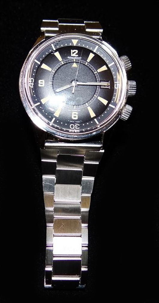The Jaeger Le Coultre Memovox wristwatch that sold at Mid-Hudson Auction Galleries to a LiveAuctioneers bidder for $15,600 had a black dial and a stainless steel case and bracelet. Image courtesy of LiveAuctioneers.com and Mid-Hudson Auction Galleries.