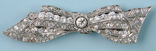 Platinum and diamond bow pin with 14K white gold clasp, approximately 5 carats total weight. Estimate: $3,200-$3,500. Image courtesy of Kaminski Auctions.