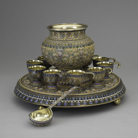 Russian enameled gilt silver punch set, Moscow, 1892. 88 Lev Oleks assayer. Effaced marks: Ovchinnikov and Imperial warrant. Bulbous punch bowl and 10 hook handled cups on stepped ball footed plateau. Intricate cloisonne in floral, scroll and geometric motifs on stippled ground, matching ladle. Estimate: $25,000-$35,000. Image courtesy of Rago Arts and Auction Center.