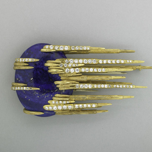 Large jeweled gold comet brooch, circa 1970, oval lapis cabochon with textured gold and diamond trails, approximately 1.60 carats, 3 1/8 x 1 5/8 inches. Estimate: $3,500-$4,500. Rago Arts and Auction Center.
