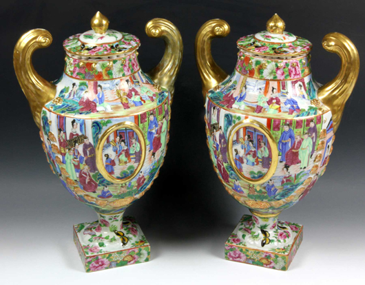 Pair of rose mandarin urns, China, 18th century, decorated with figures in courtyard scenes, 14 3/4 inches high x 8 3/4 inches wide. Estimate: $16,000-$21,000.