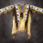 An example of a circa-1880 Sioux beaded shirt, this one features pictorial beaded strips over the shoulders and down the sleeves, with hand and geometric designs in red blue and green on a white field. Auctioned for $84,000 (inclusive of 20% buyer's premium) on Jan. 29, 2011 by High Noon Western Americana. Image courtesy of LiveAuctioneers.com Archive and High Noon Western Americana.