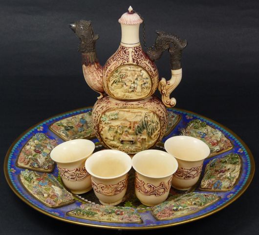 Impressive six-piece 18th century Chinese relief carved ivory and cloisonné tea set. Realized $10,620. Image courtesy of Elite Decorative Arts. 